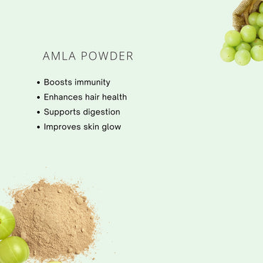 Amla powder with amla fruits on a light green background