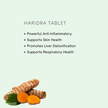 Haridra tablet with turmeric root and leaves on a light green background