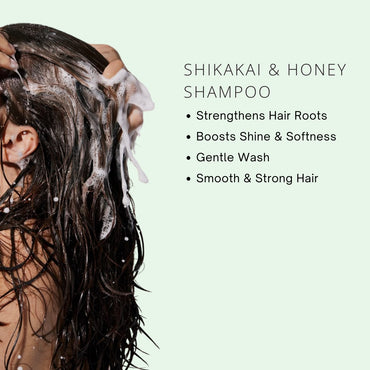 Person washing hair with Shikakai & Honey Shampoo on a light green background